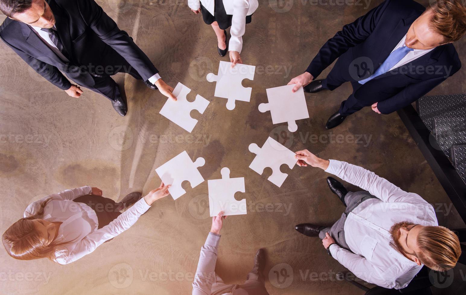 Teamwork of partners. Concept of integration and startup with puzzle pieces photo