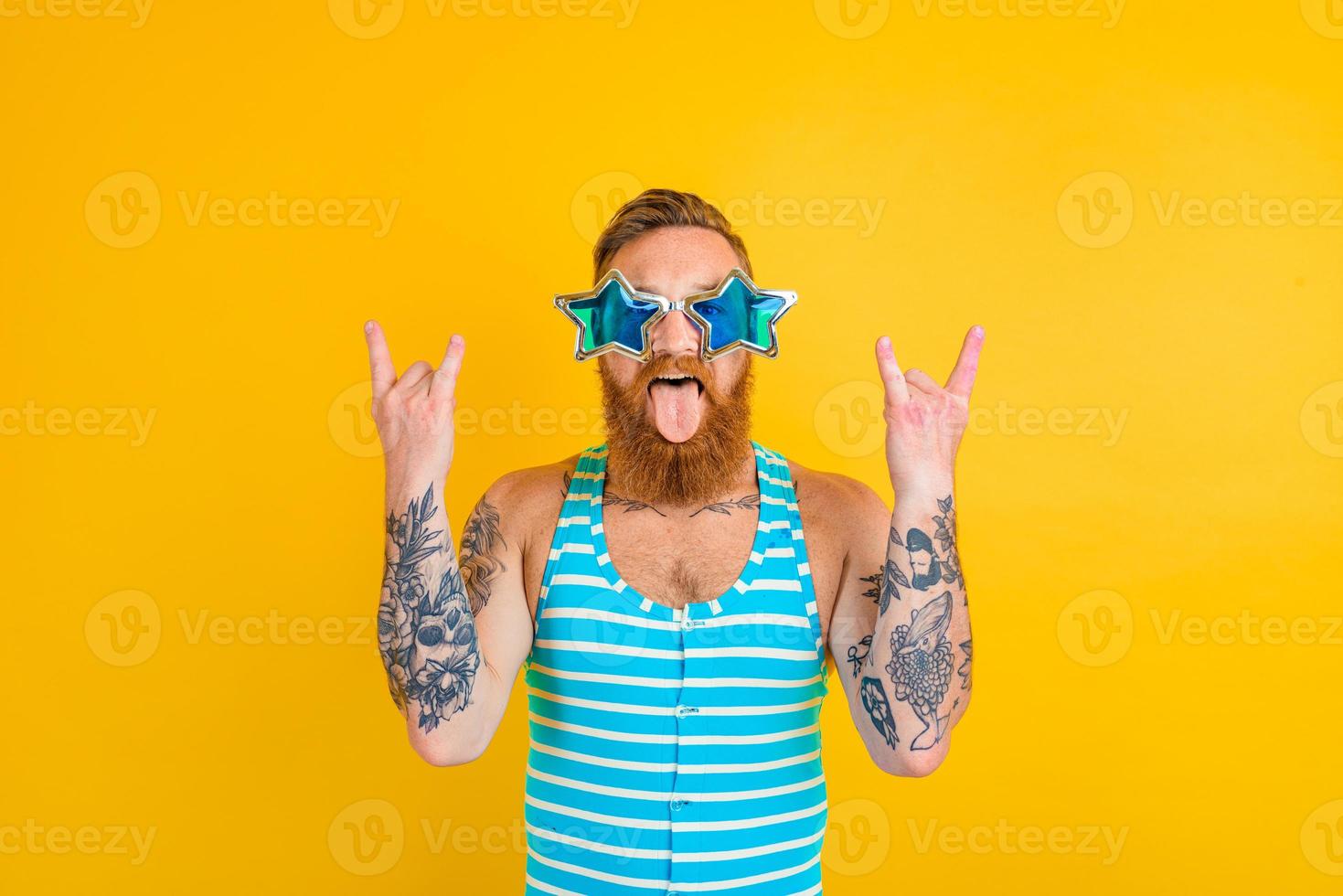 man with beard,tattoos and swimsuit is ready for the summer photo