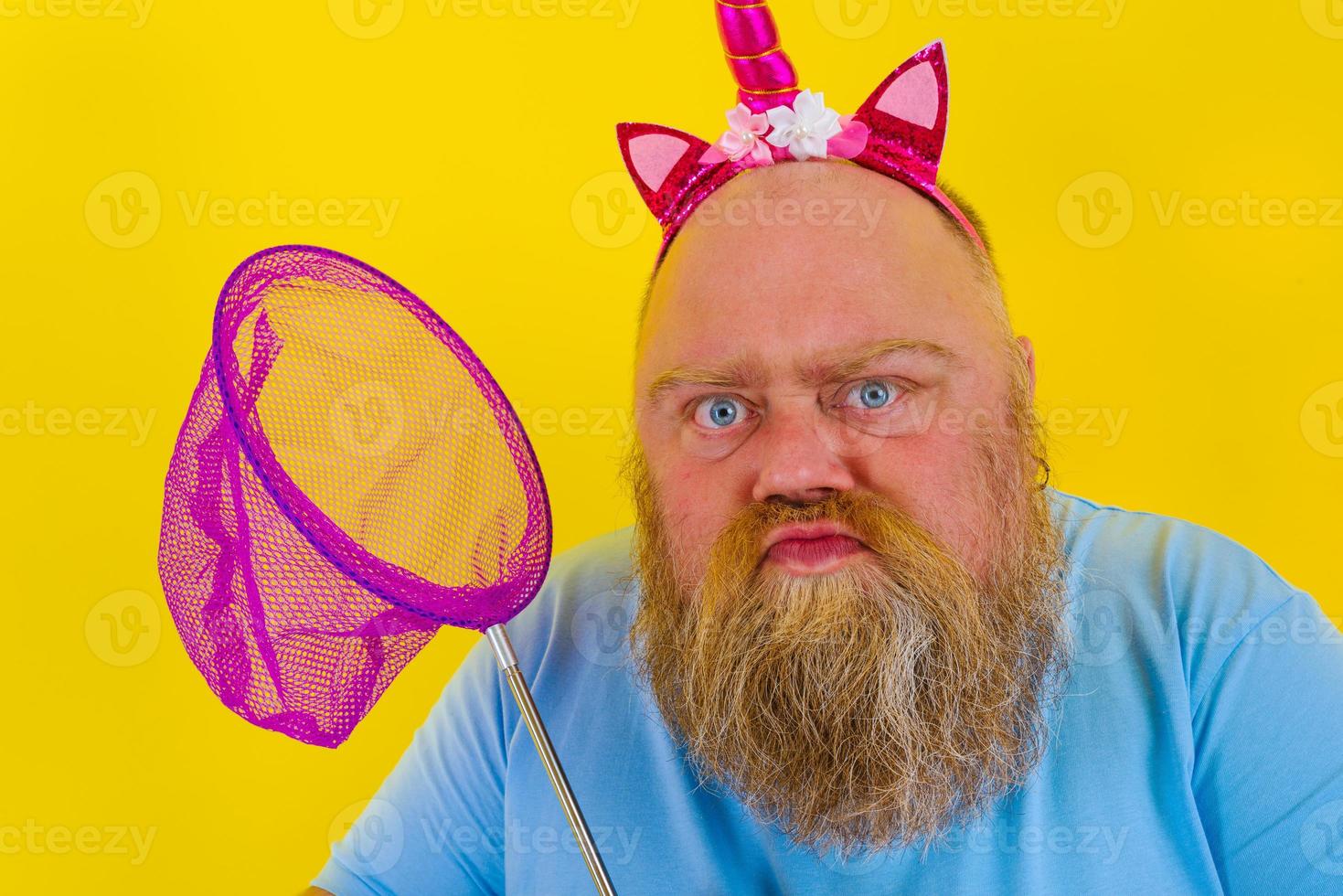 Fat thoughtful man with headband play with sea net photo