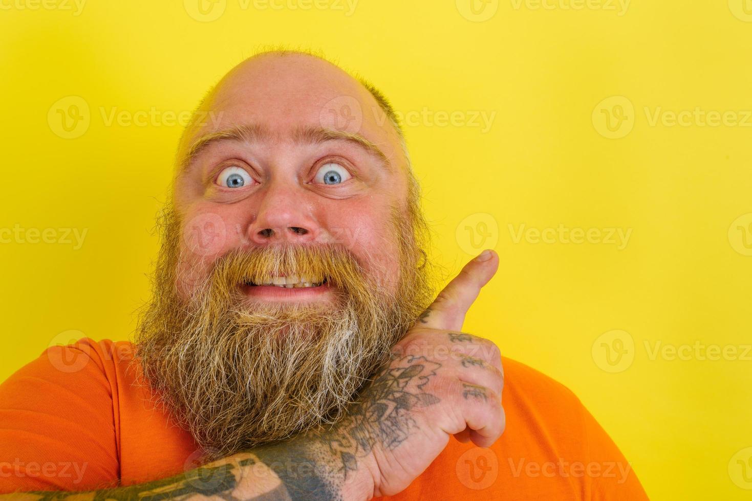 Afraid man with beard and tattoos is worried about something photo