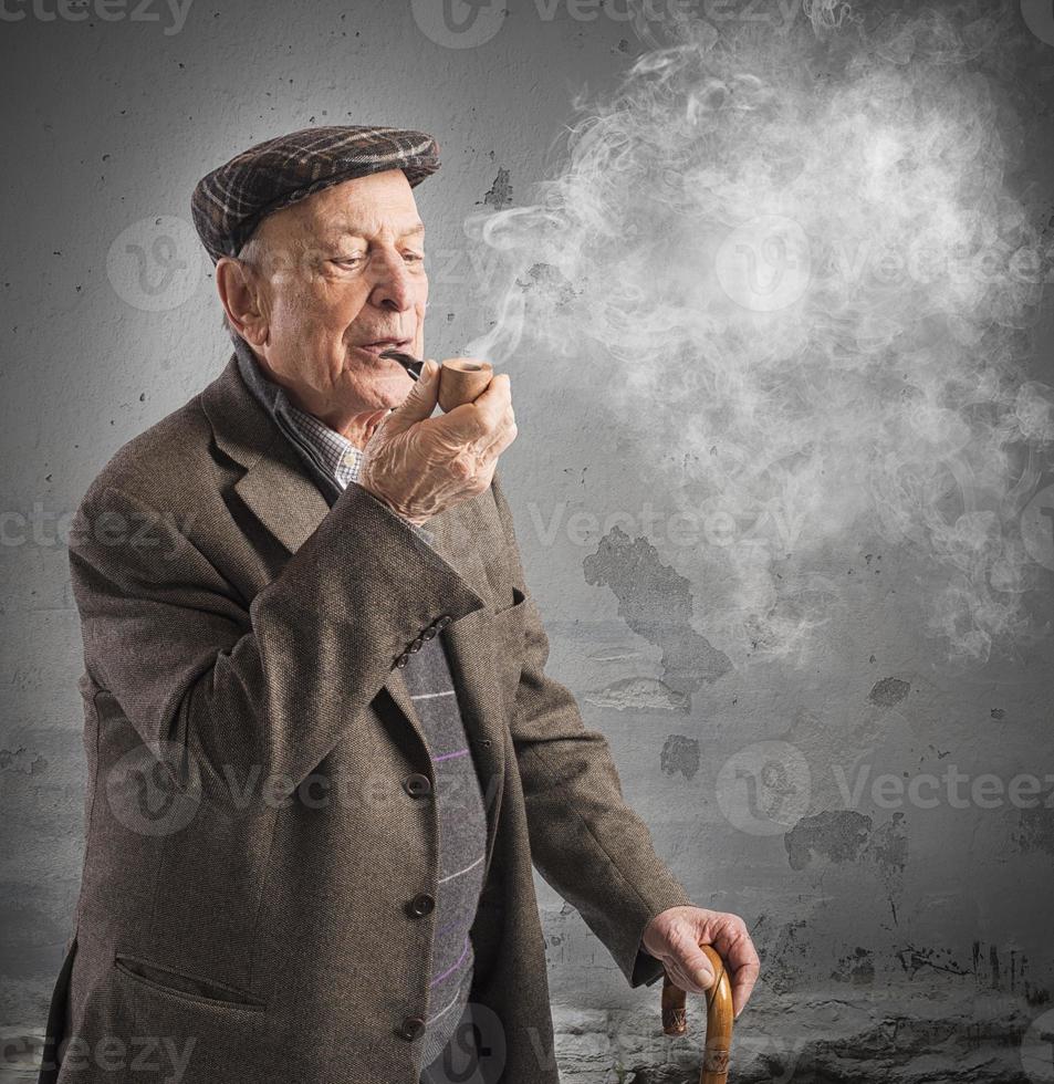 Old man smoking pipe photo