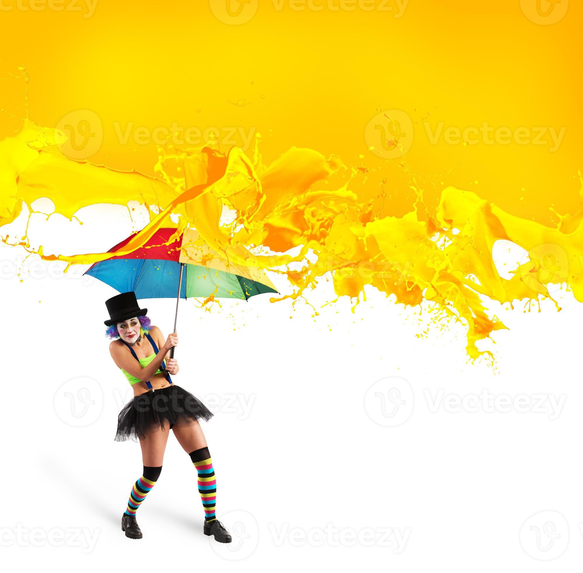 Clown with umbrella covers himself from yellow color drops 20554722 Stock Photo at Vecteezy