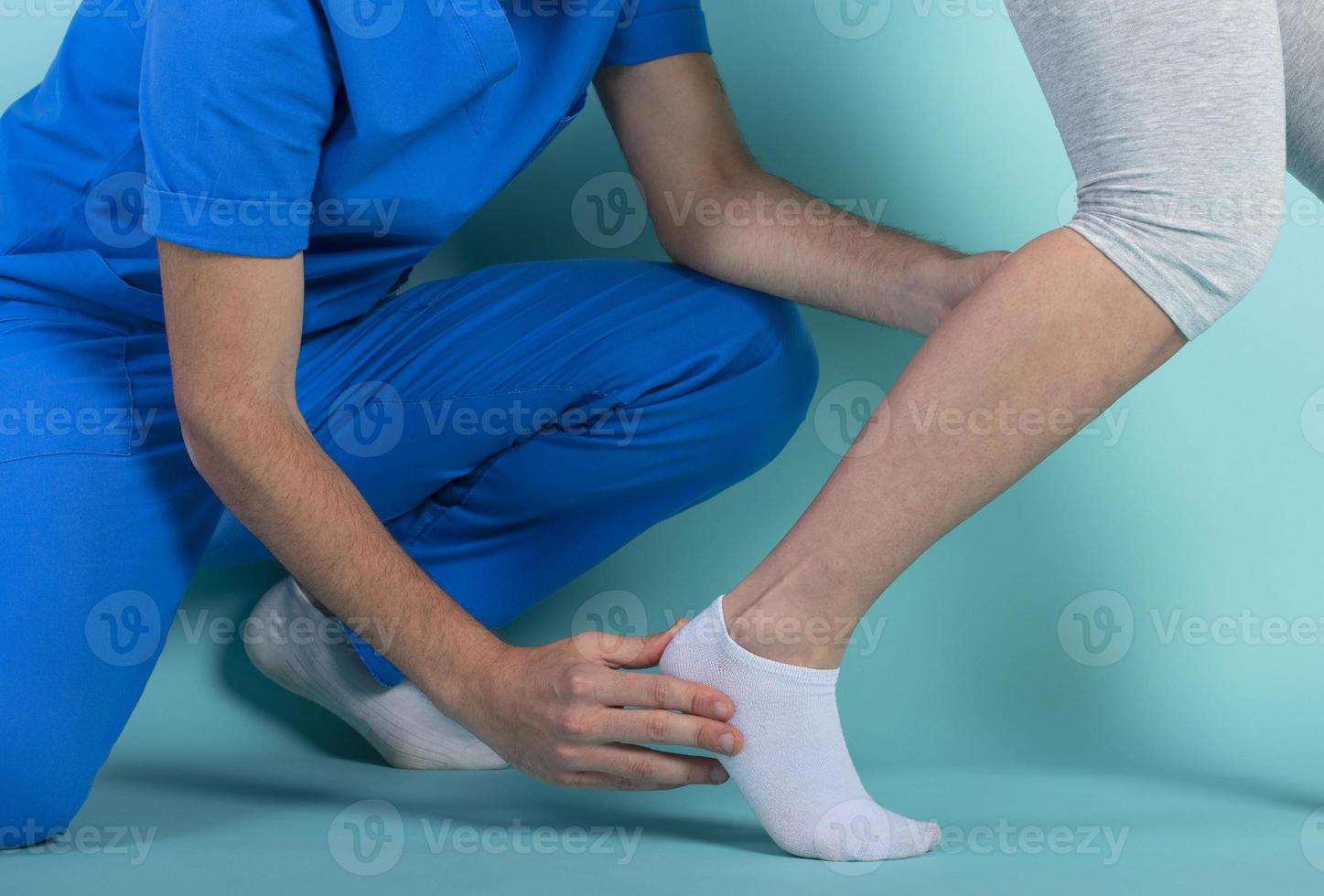 woman performs exercises with a physiotherapist. Cyan background photo