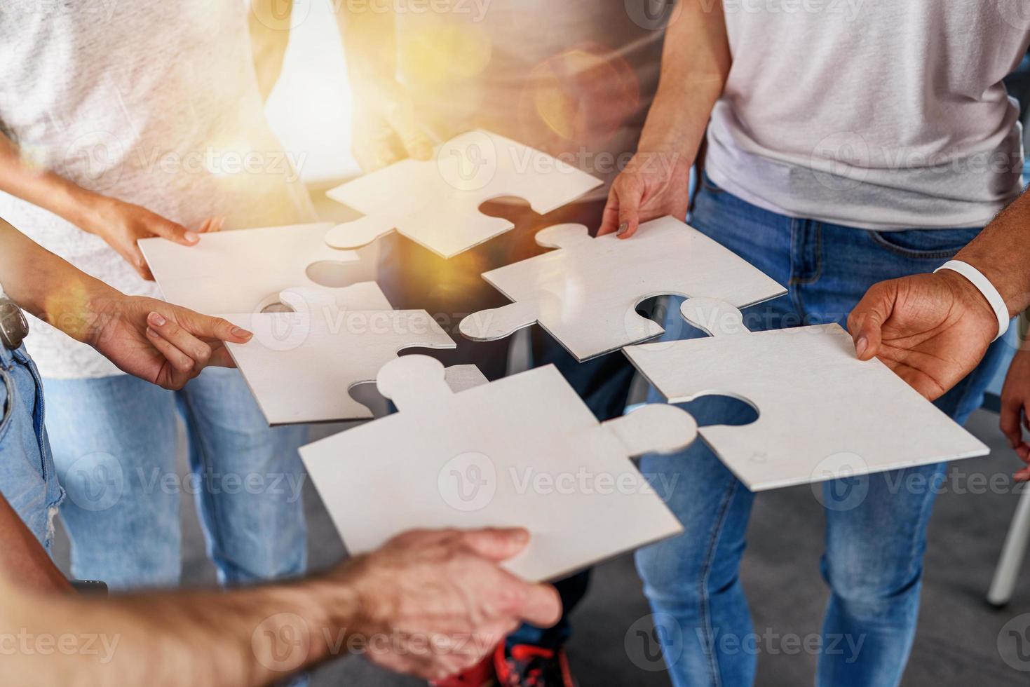 Teamwork of partners connect puzzle pieces as integration and startup photo