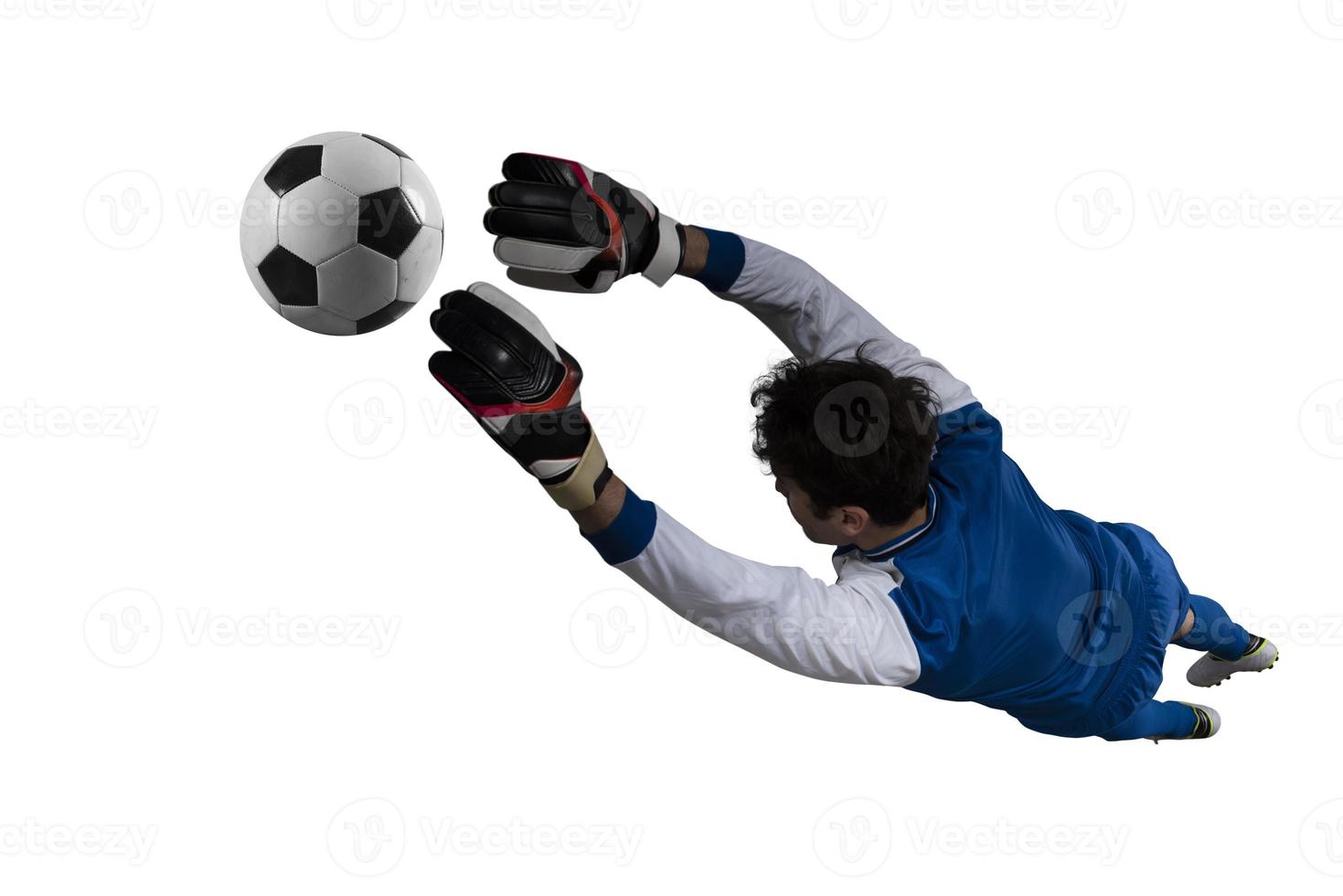 Goalkeeper catches the ball in the stadium during a football game. Isolated on white background photo