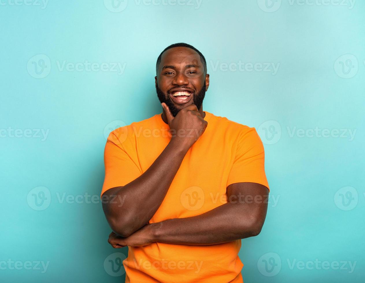 Joyful and happy guy over cyan background photo