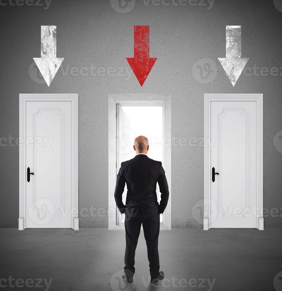 Concept of businessman choosing the right door photo