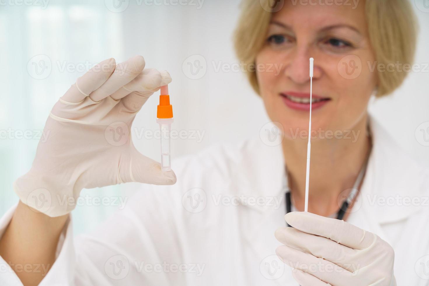 Doctor is checking the covid 19 with a tester photo