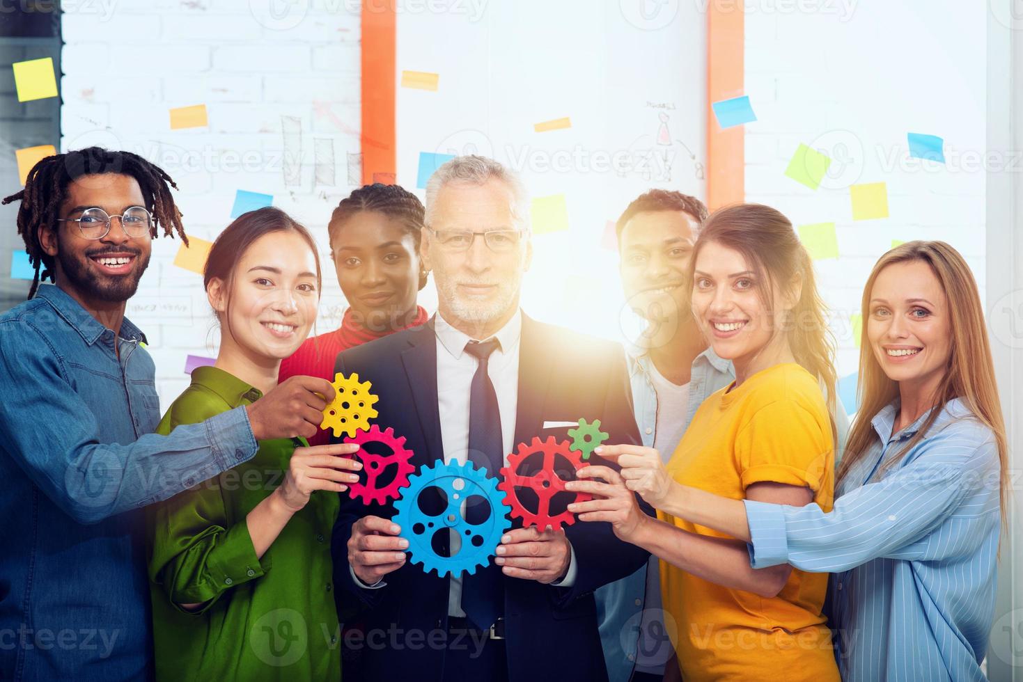 Business team connect pieces of gears. Teamwork, partnership and integration concept photo