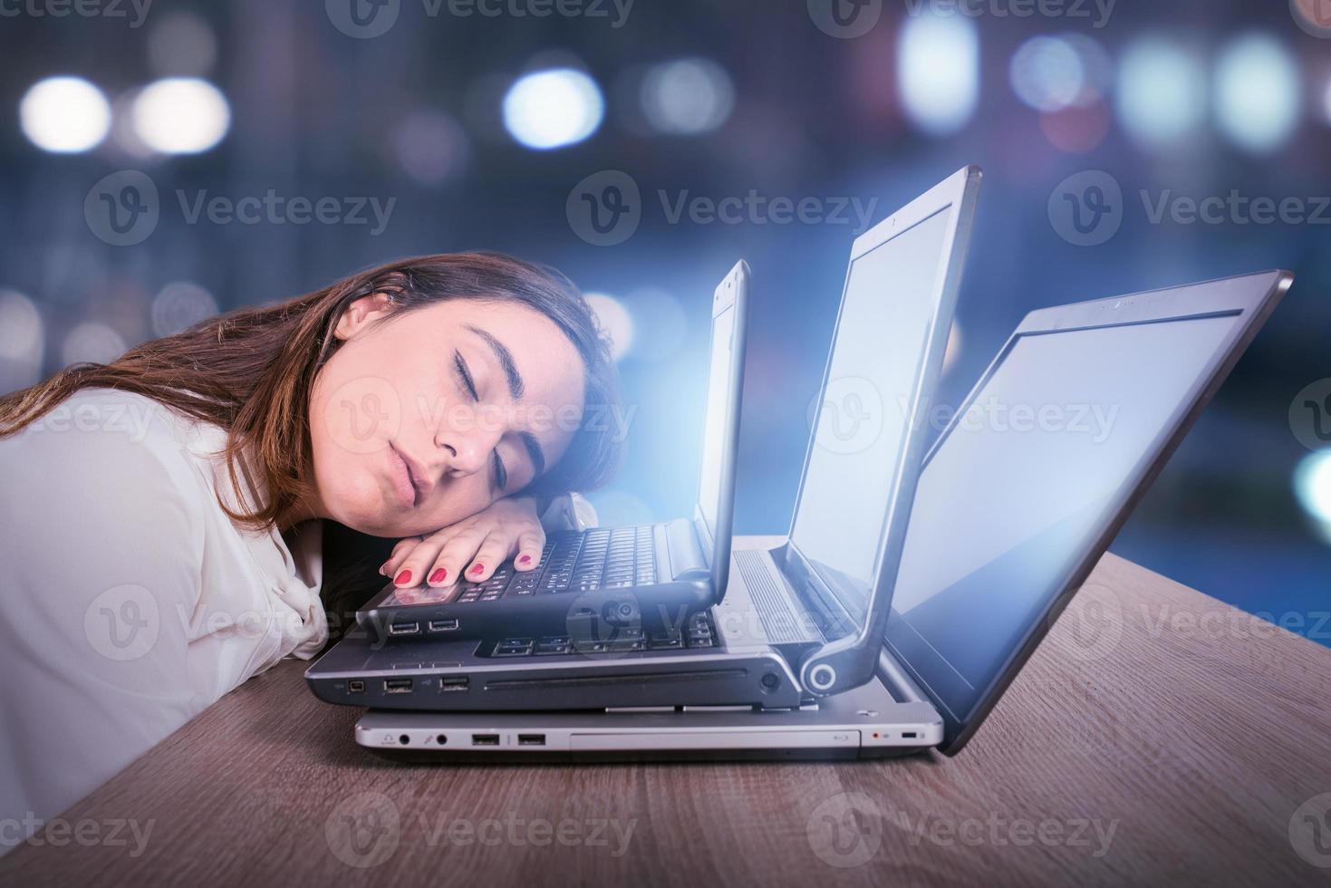 Businesswoman is tired due to too much work. Concept of stress and overwork photo