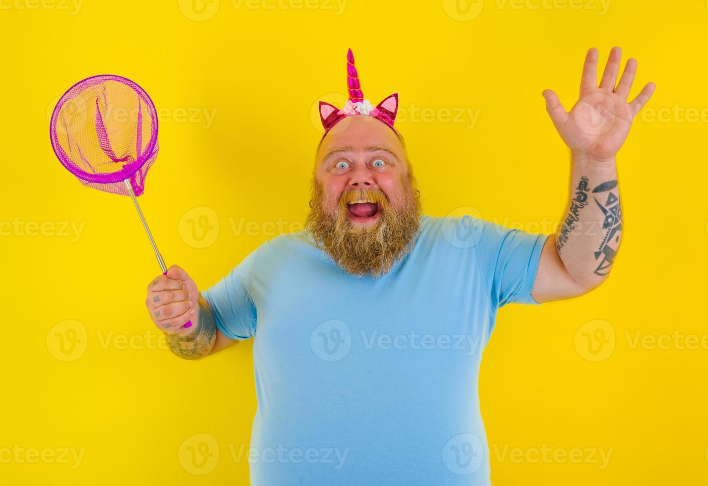Fat happy man with headband play with sea net photo