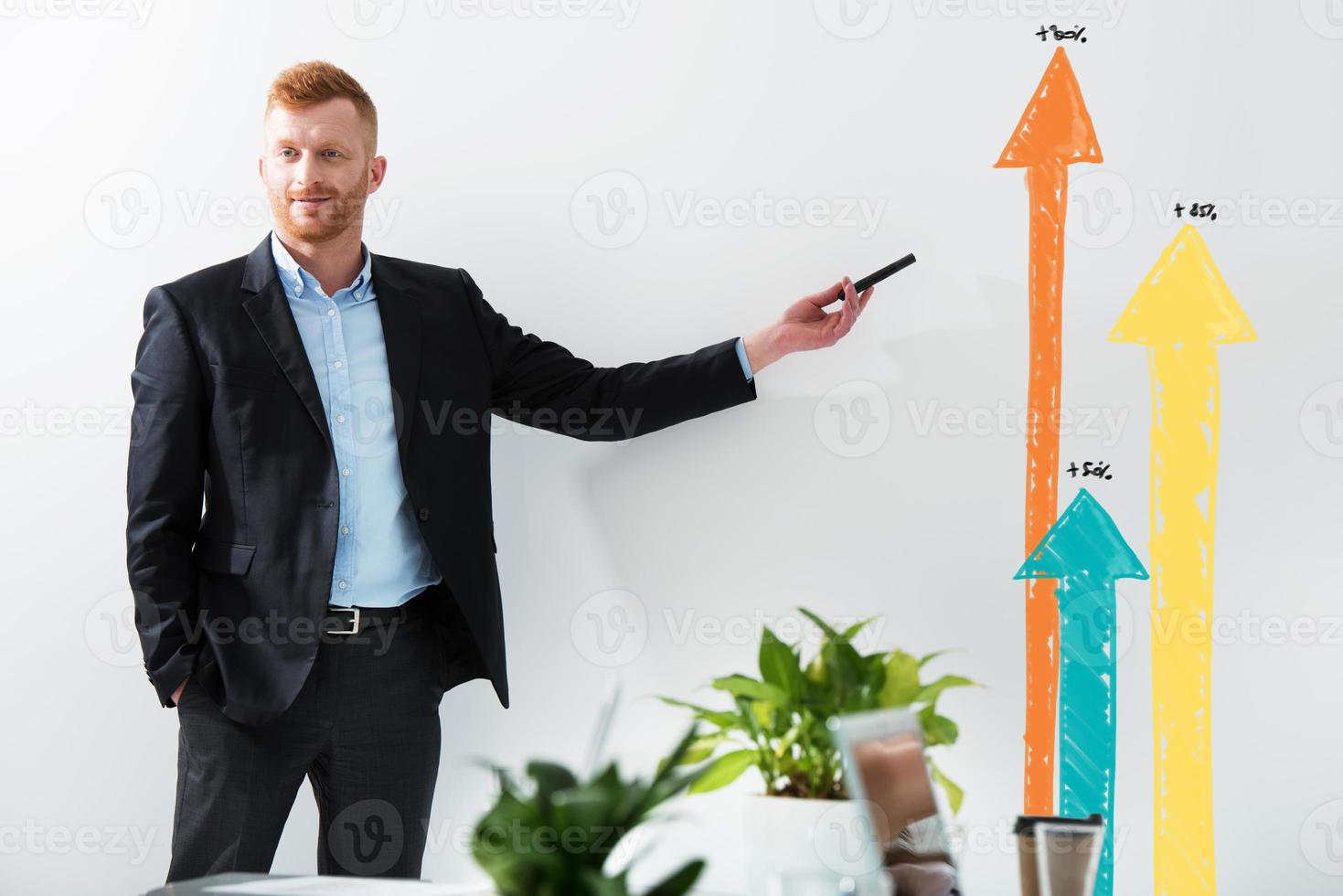 Businessman draws positive statistics of his company. Concept of success photo