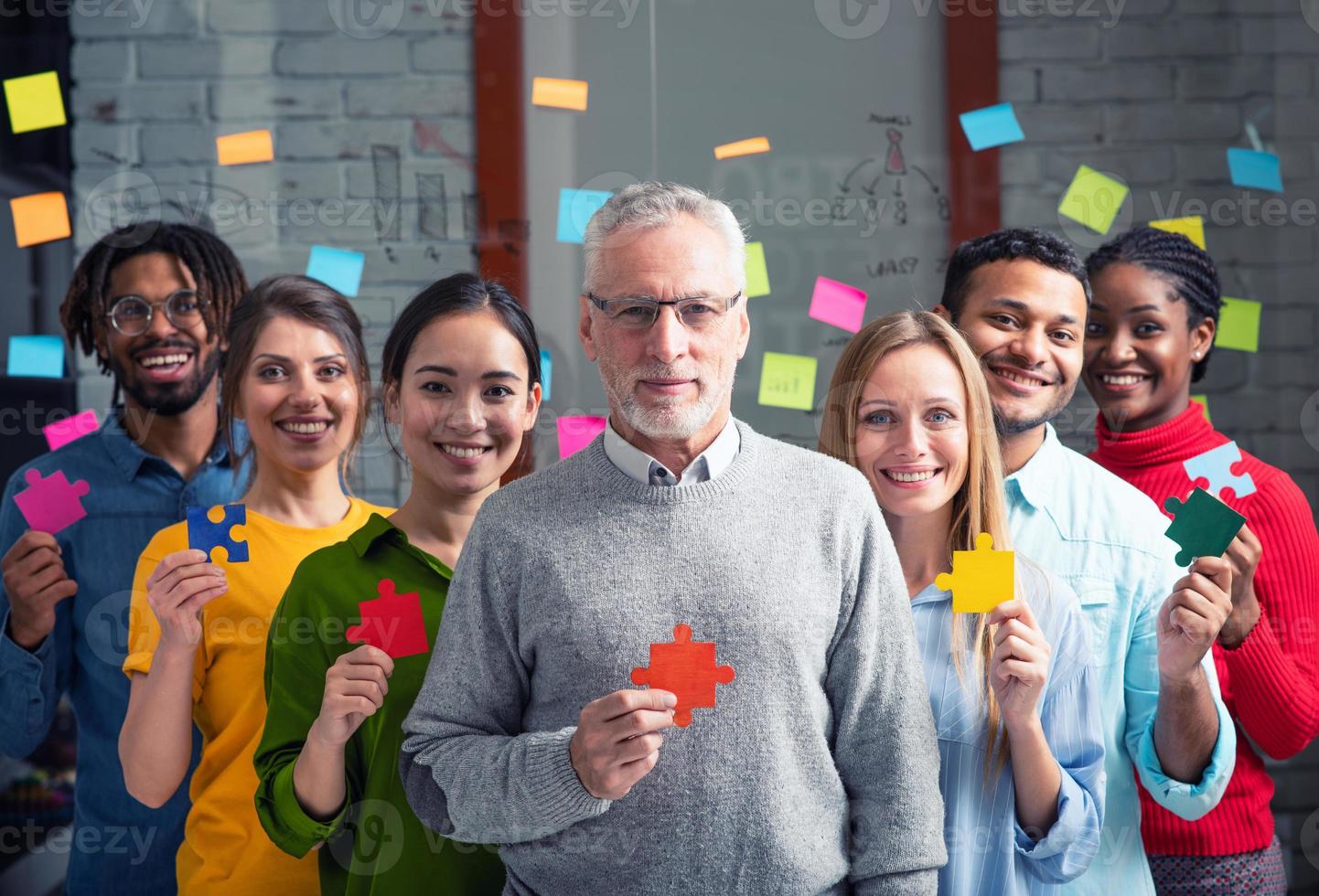 Teamwork of partners that work together. Concept of integration and startup with colored puzzle pieces photo