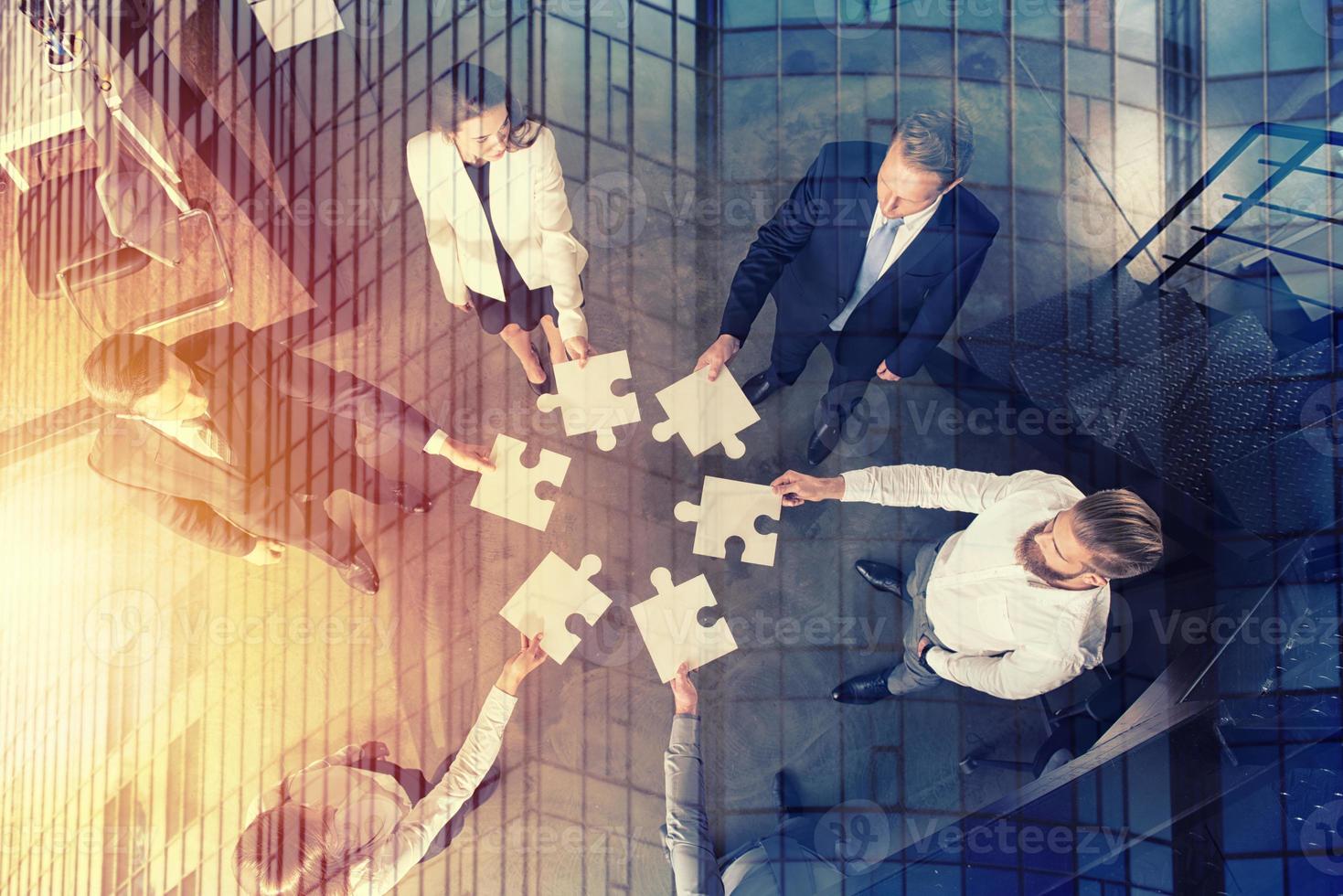 Teamwork of partners. Concept of integration and startup with puzzle pieces photo