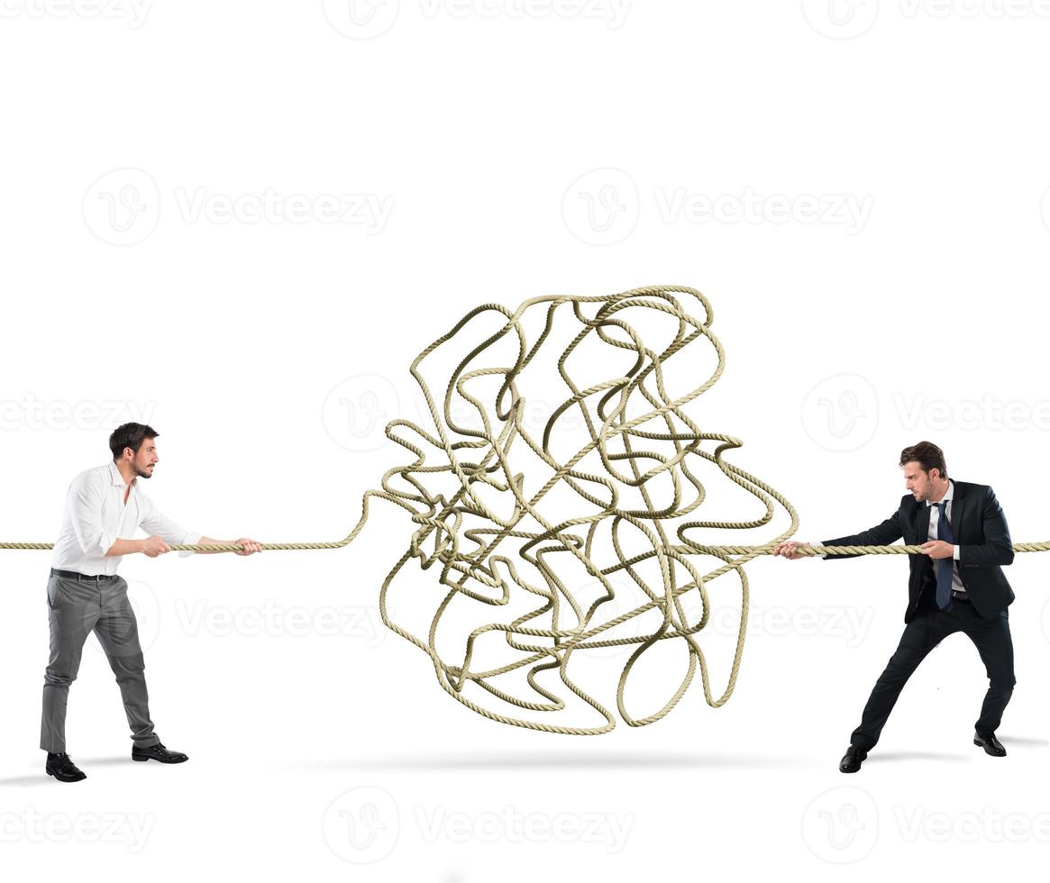 Businessmen try to solve a tangled rope. Concept of partnership photo