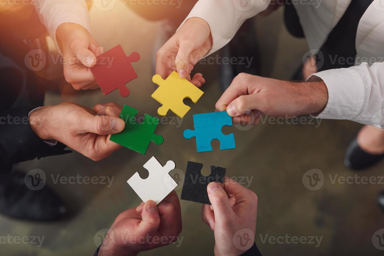 Teamwork of partners connect puzzle pieces as integration and startup photo