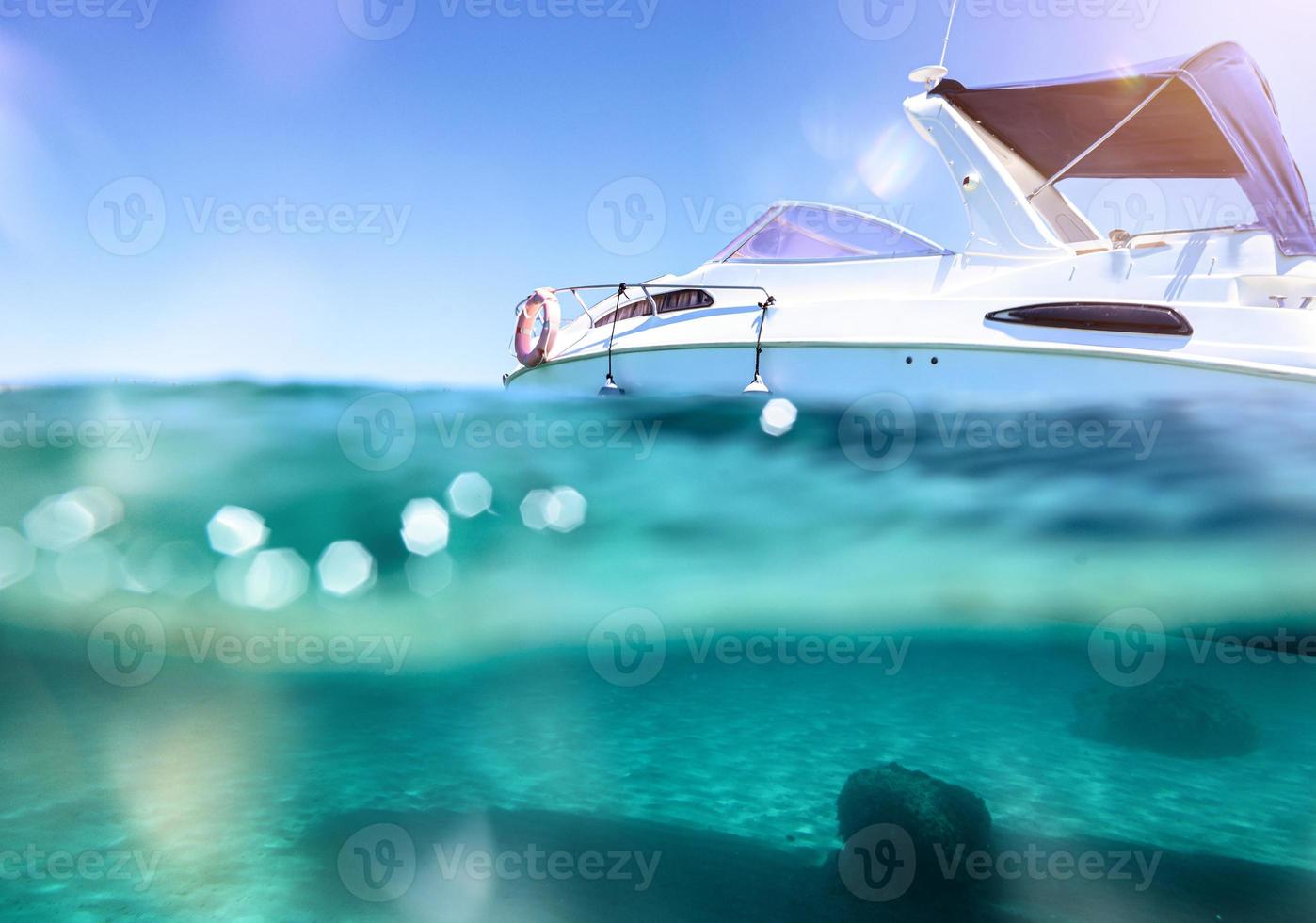 Boat floats in a crystalline and transparent sea photo