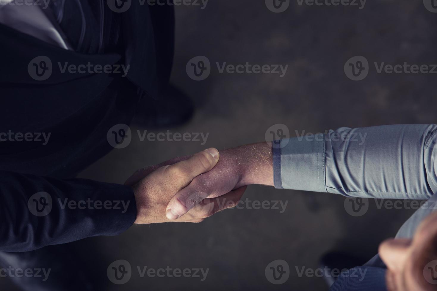 Handshaking business person in office. concept of teamwork and partnership photo