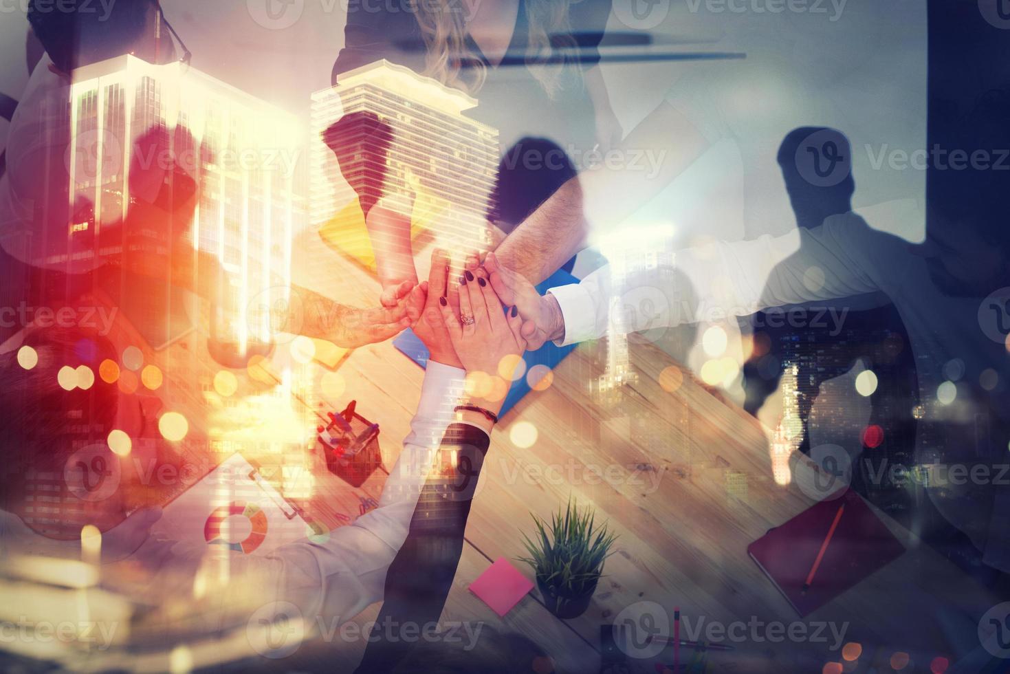 Handshaking business person in office. concept of teamwork and partnership. double exposure with light effects photo