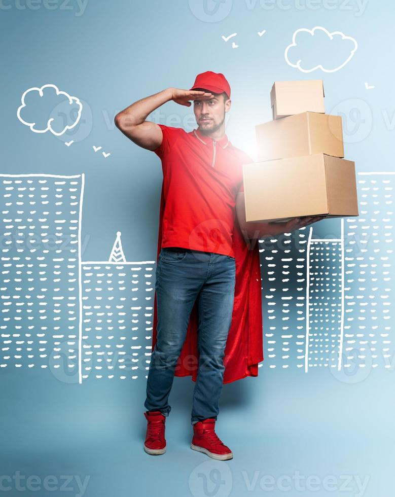 Courier acts like a powerful superhero. Concept of success and guarantee on shipment. Studio cyan background photo