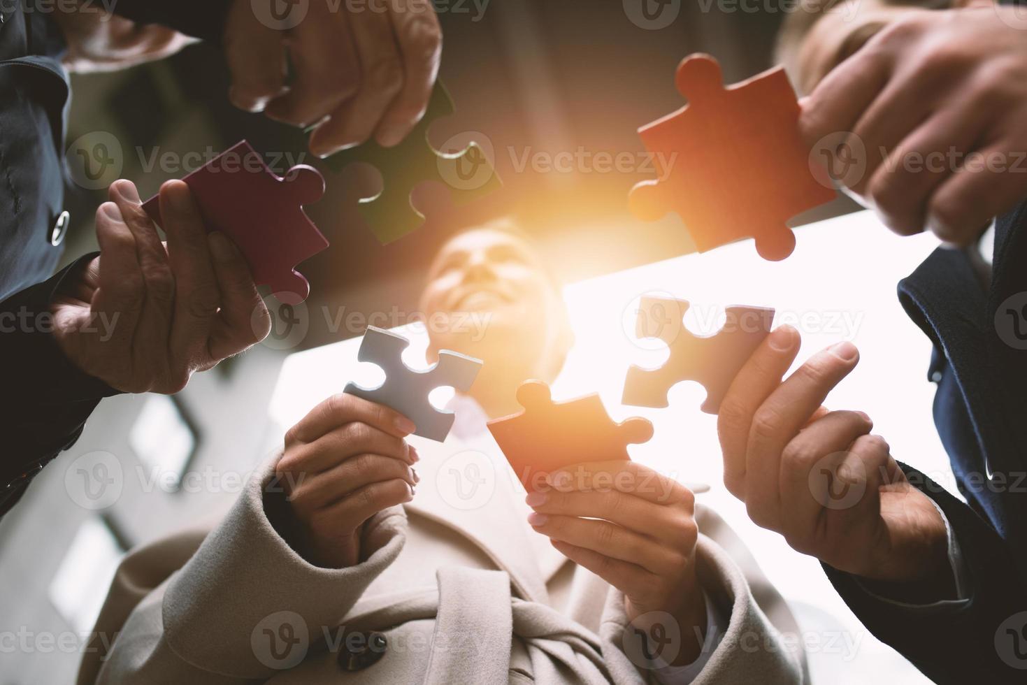 Teamwork of partners. Concept of integration and startup with puzzle pieces photo