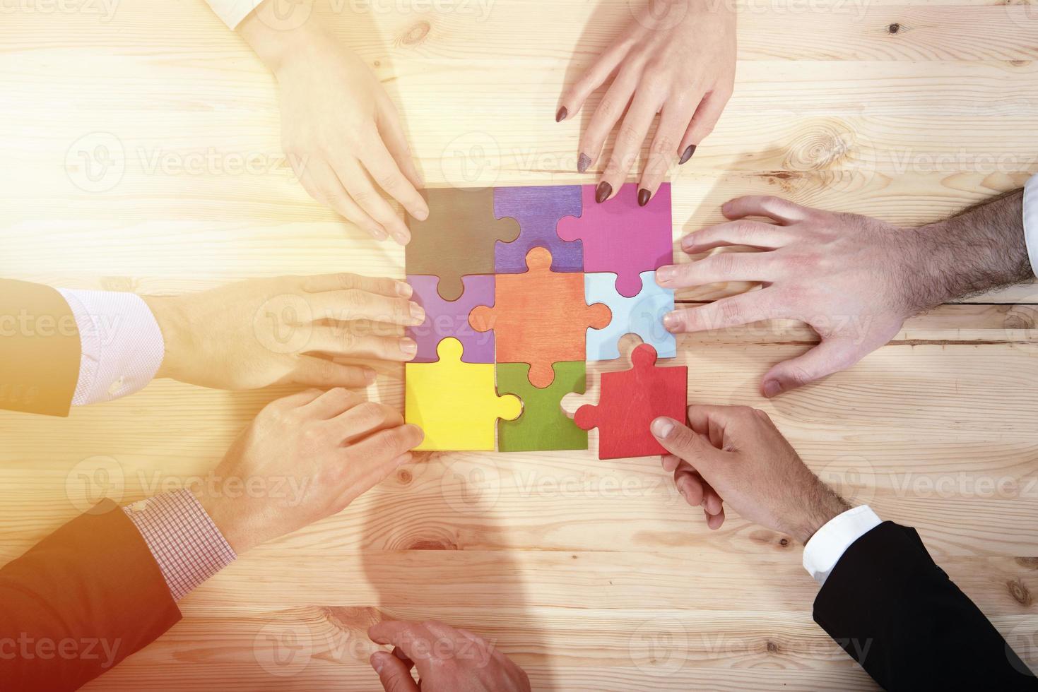 Teamwork of partners. Concept of integration and startup with puzzle pieces photo