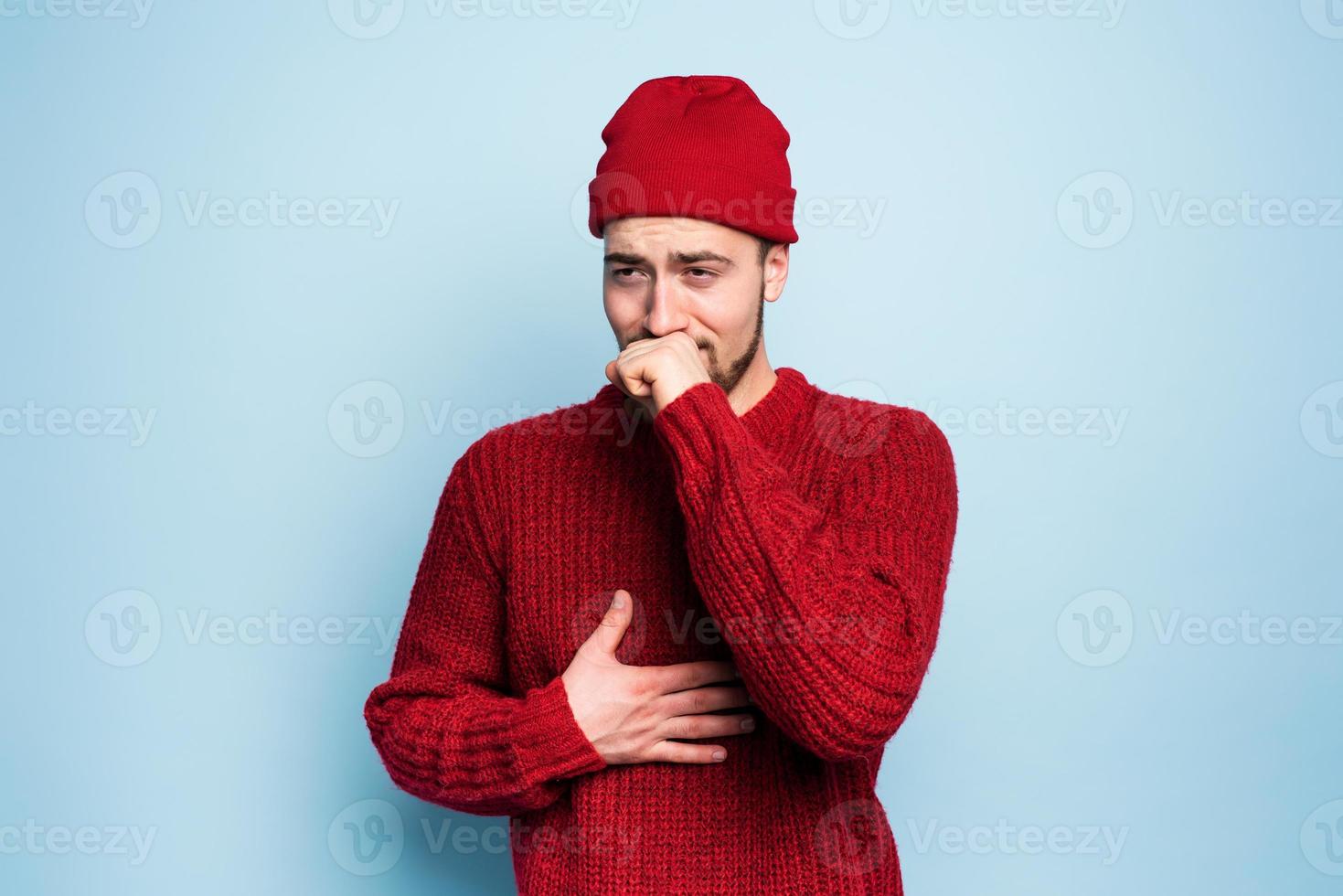 Boy caught a cold and has cough. Studio on Cyan background photo