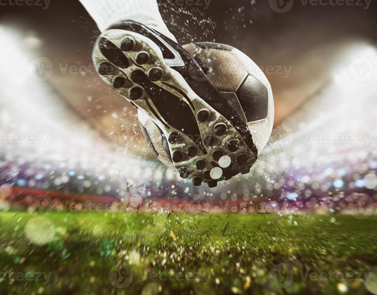 Football scene at night match with close up of a soccer shoe hitting the ball with power photo
