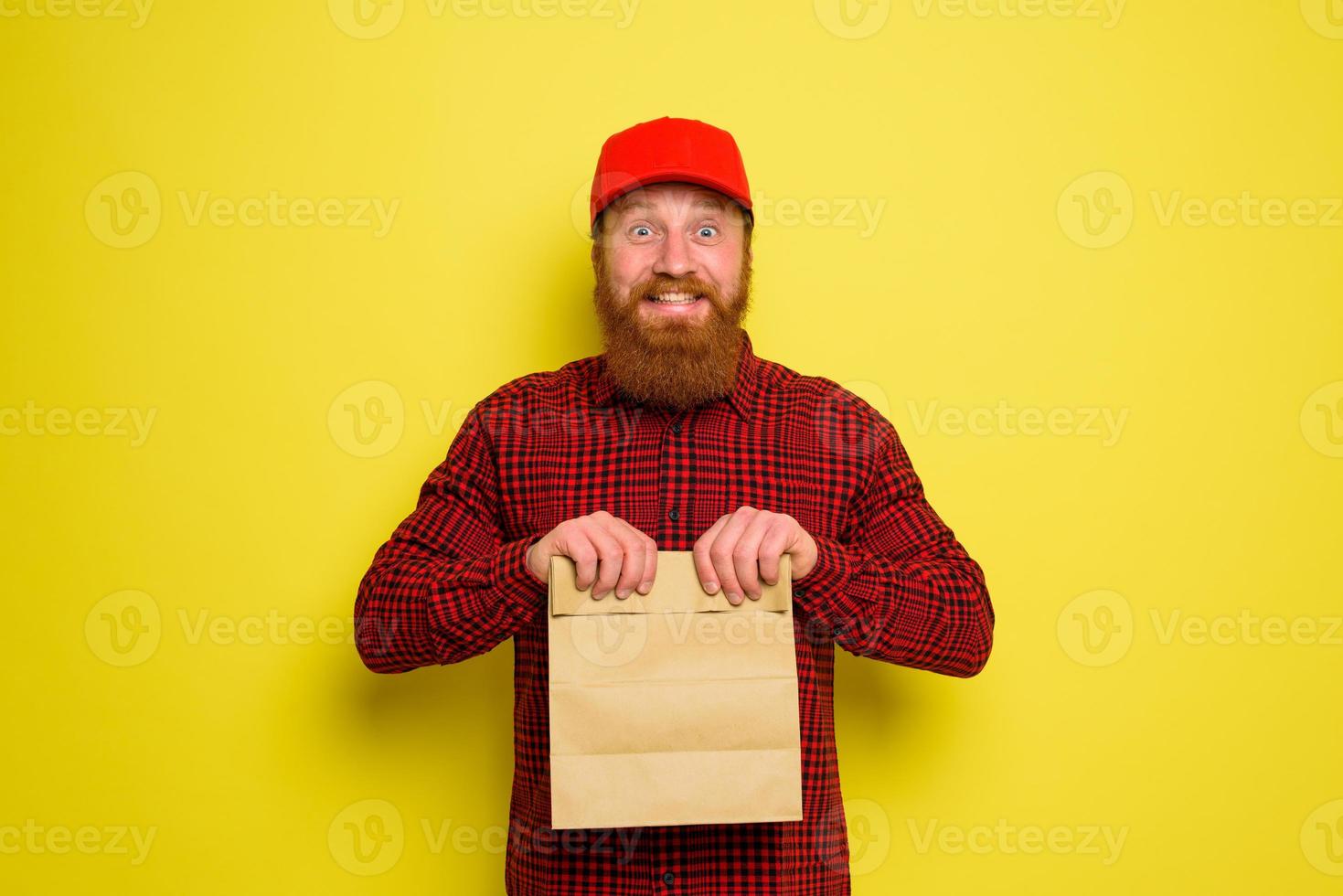 Delivery man with hat and beard has an happy expression photo