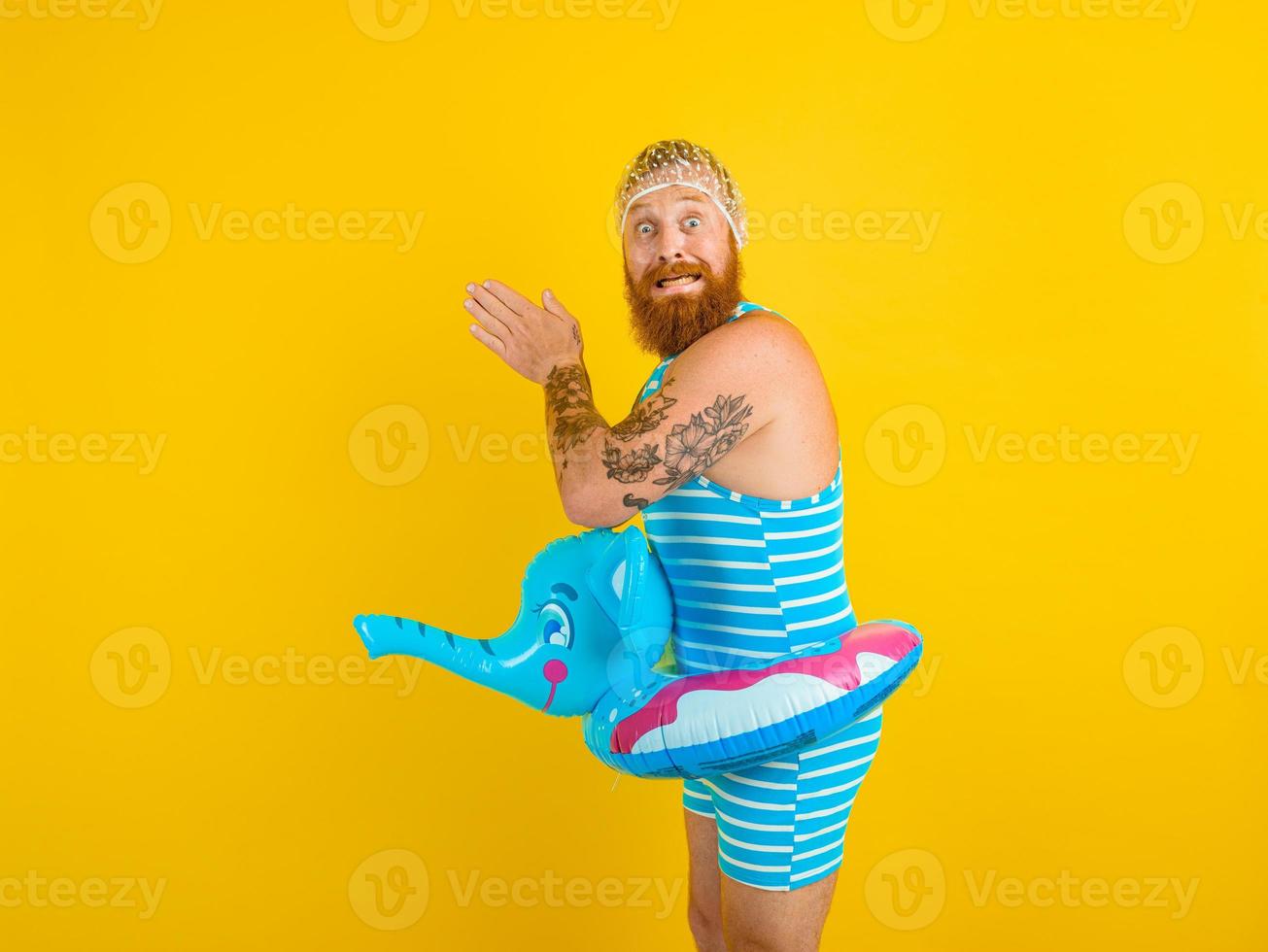 Afraid man with life buoy and hair cap for afraid women is ready for the summer photo