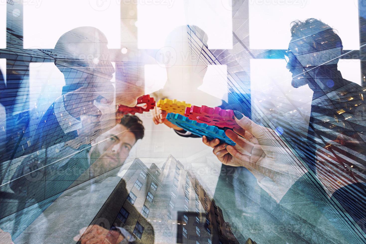 Working group of businessmen find the agreement by holding a piece of gear in hand. concept of teamwork and business partnership. double exposure photo