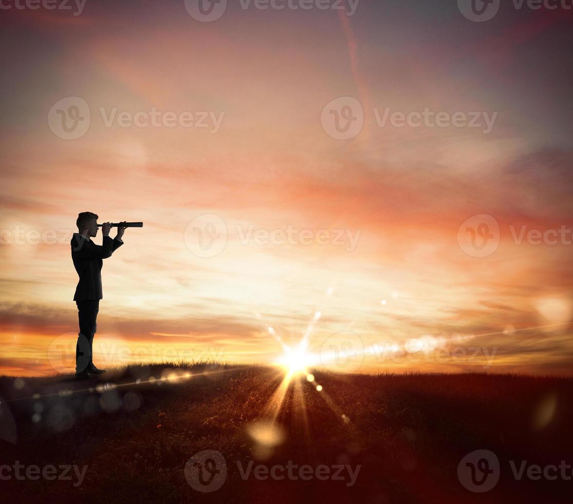 Businessman searchs for new horizon, new business opportunities photo