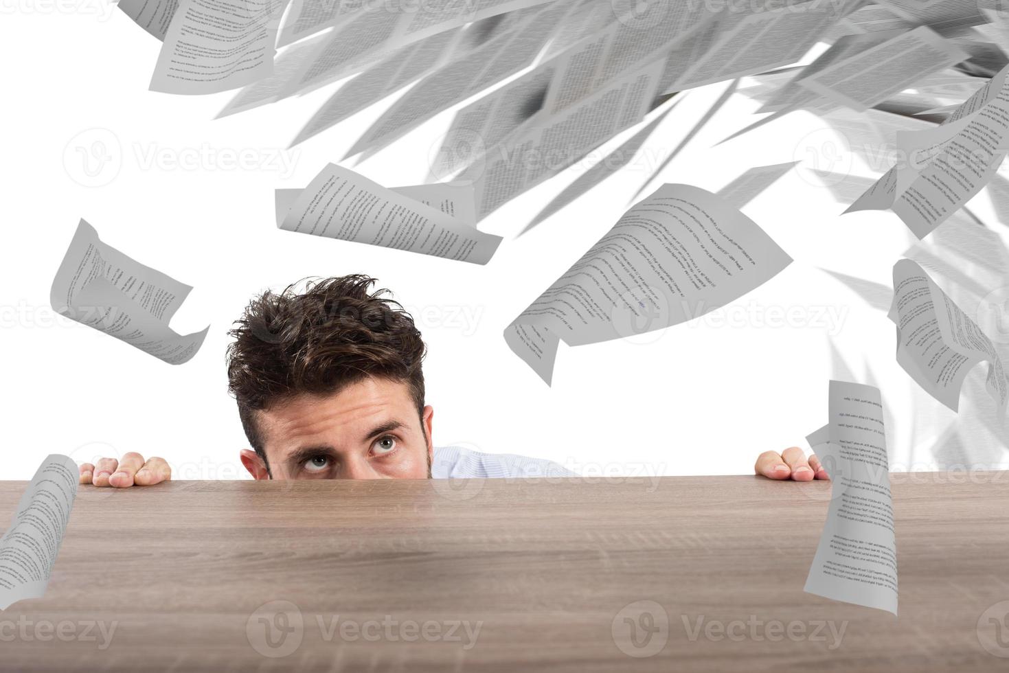 Businessman afraid under the desk. concept of overwork photo
