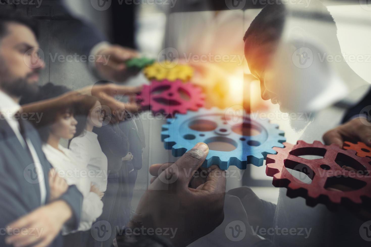 Business team connect pieces of gears. Teamwork, partnership and integration concept. double exposure photo