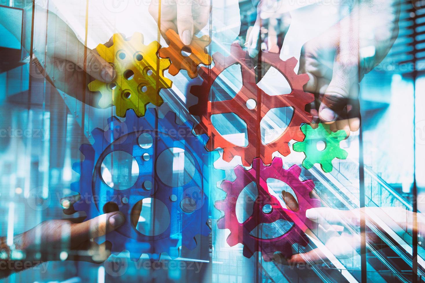 Business team connect pieces of gears. Teamwork, partnership and integration concept. double exposure with light effects photo
