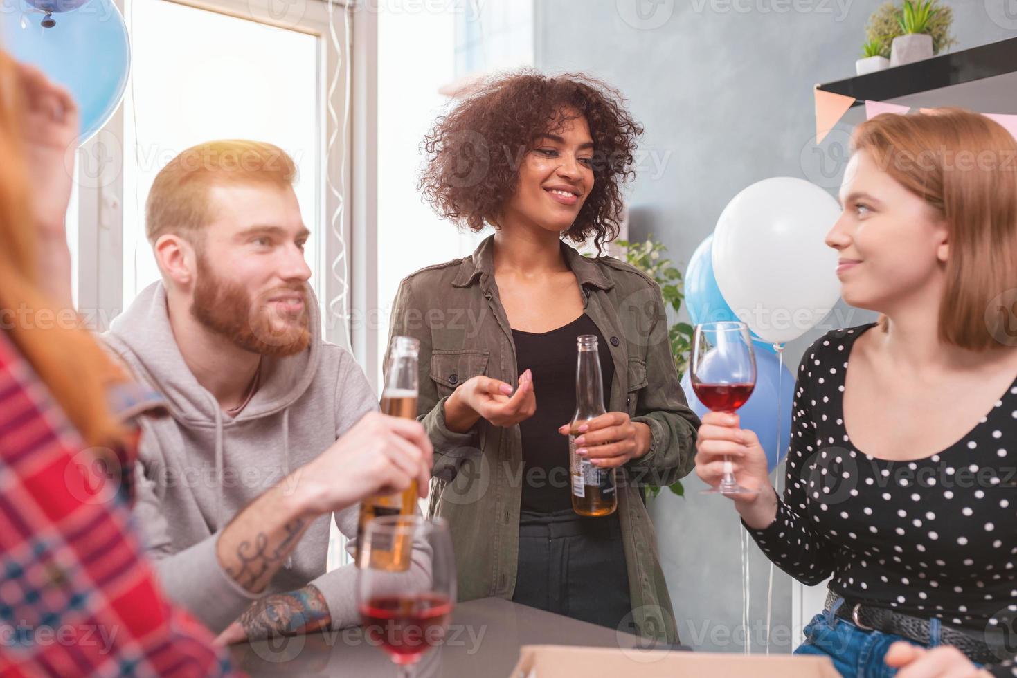 Festive party among multi-ethnic friends at home photo