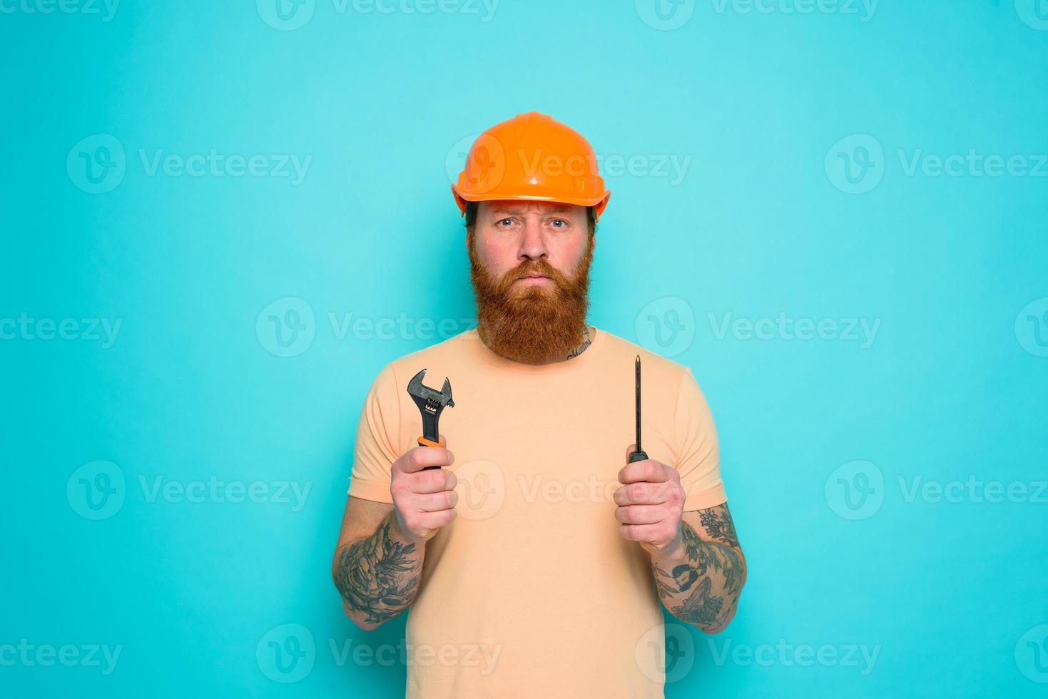 Worker with yellow hat is confused about his work photo