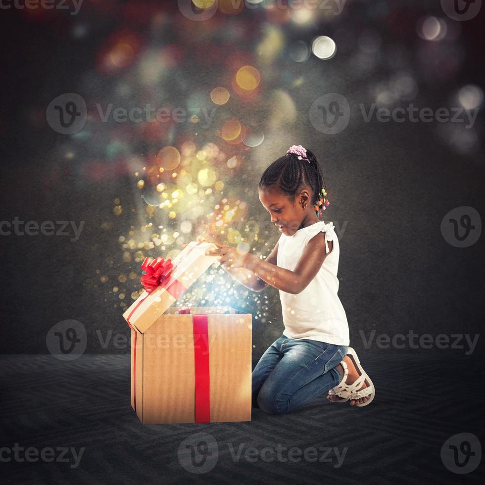 Happy little girl with a Christmas gift photo