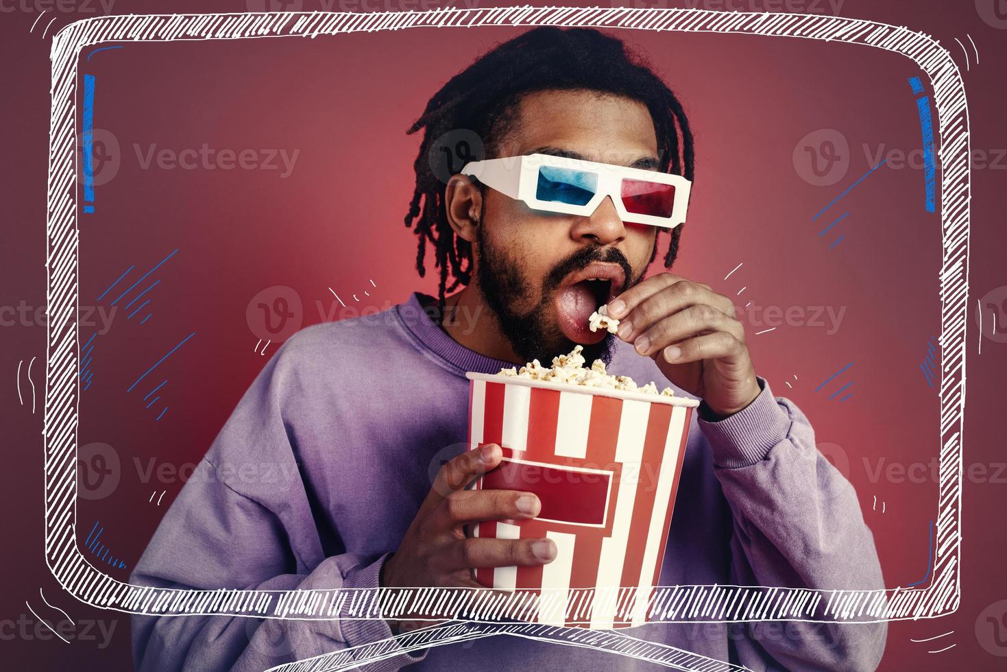 Boy has fun watching a film. Concept of entertainment and streaming tv. red background photo