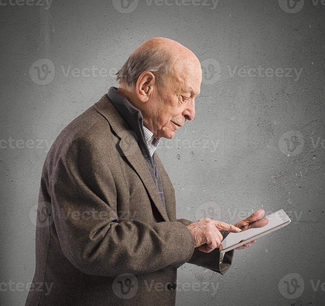 Old man surfing internet photo