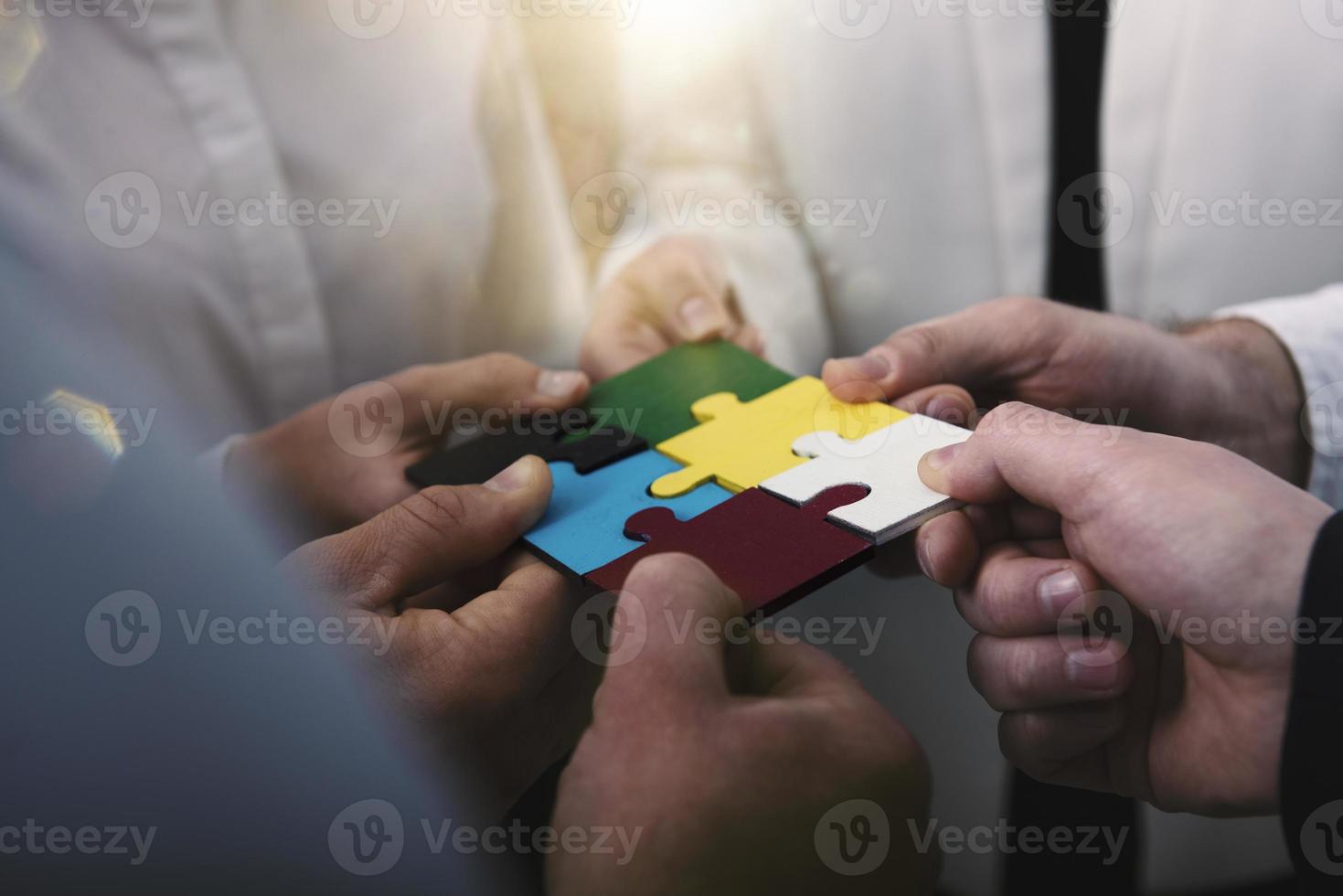Teamwork of partners. Concept of integration and startup with puzzle pieces photo