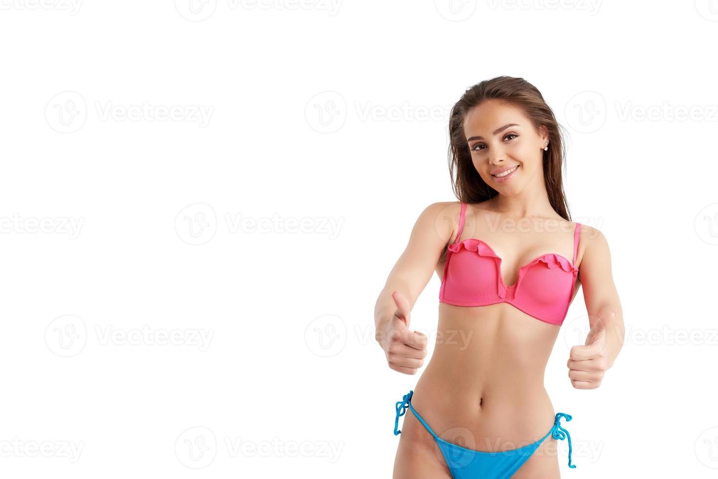 Happy girl in swimsuit say yes with hand photo