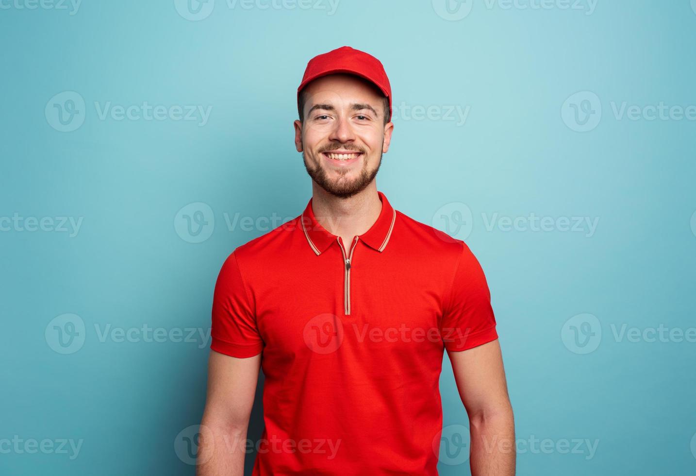 Smiling courier is happy to work. Emotional expression. Cyan background photo
