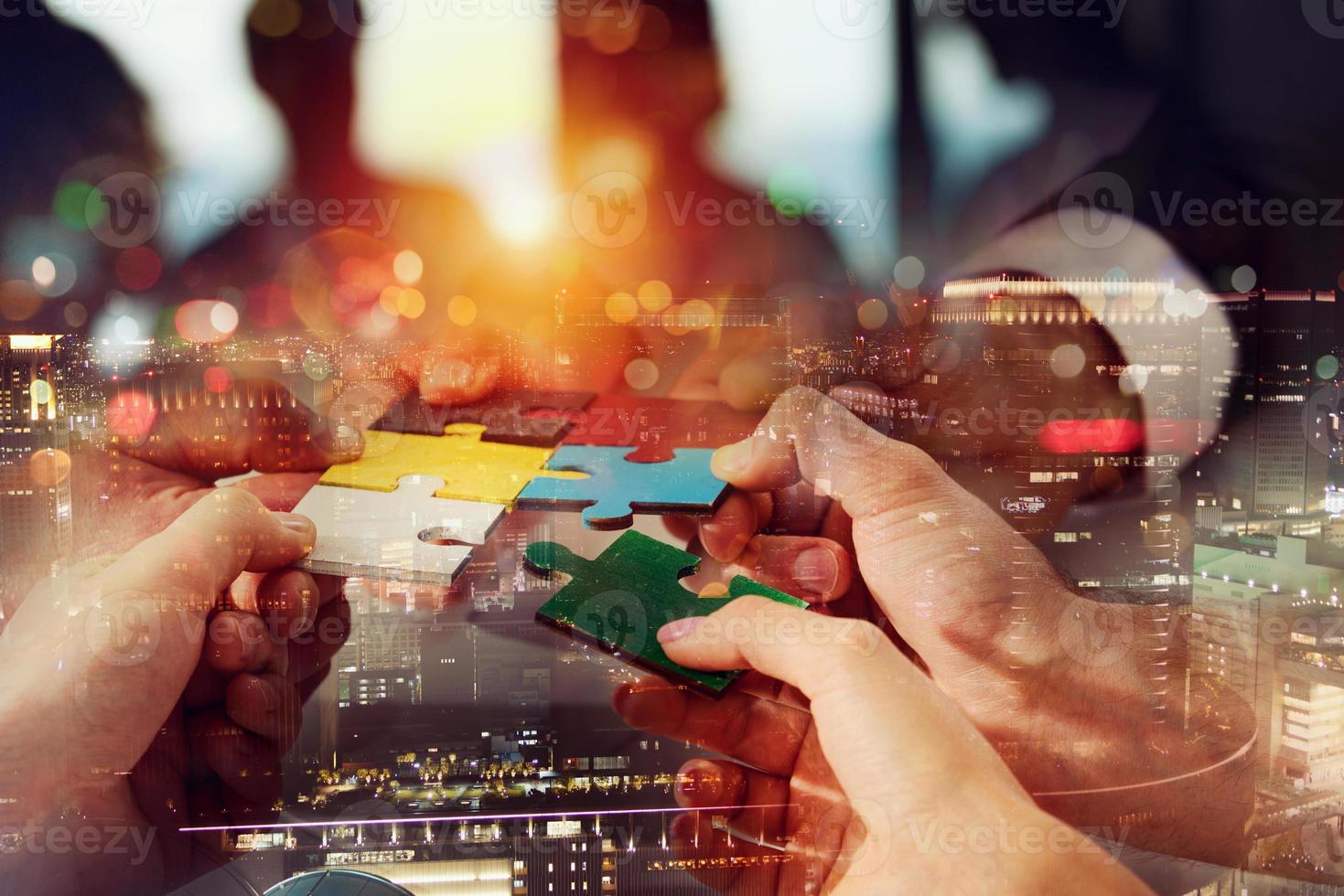 Teamwork of partners connect puzzle pieces as integration and startup photo