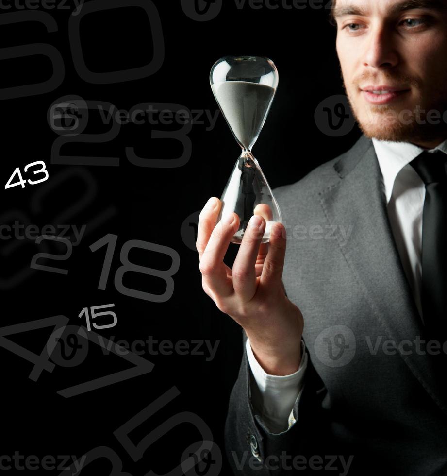 Businessman holding a hourglass photo