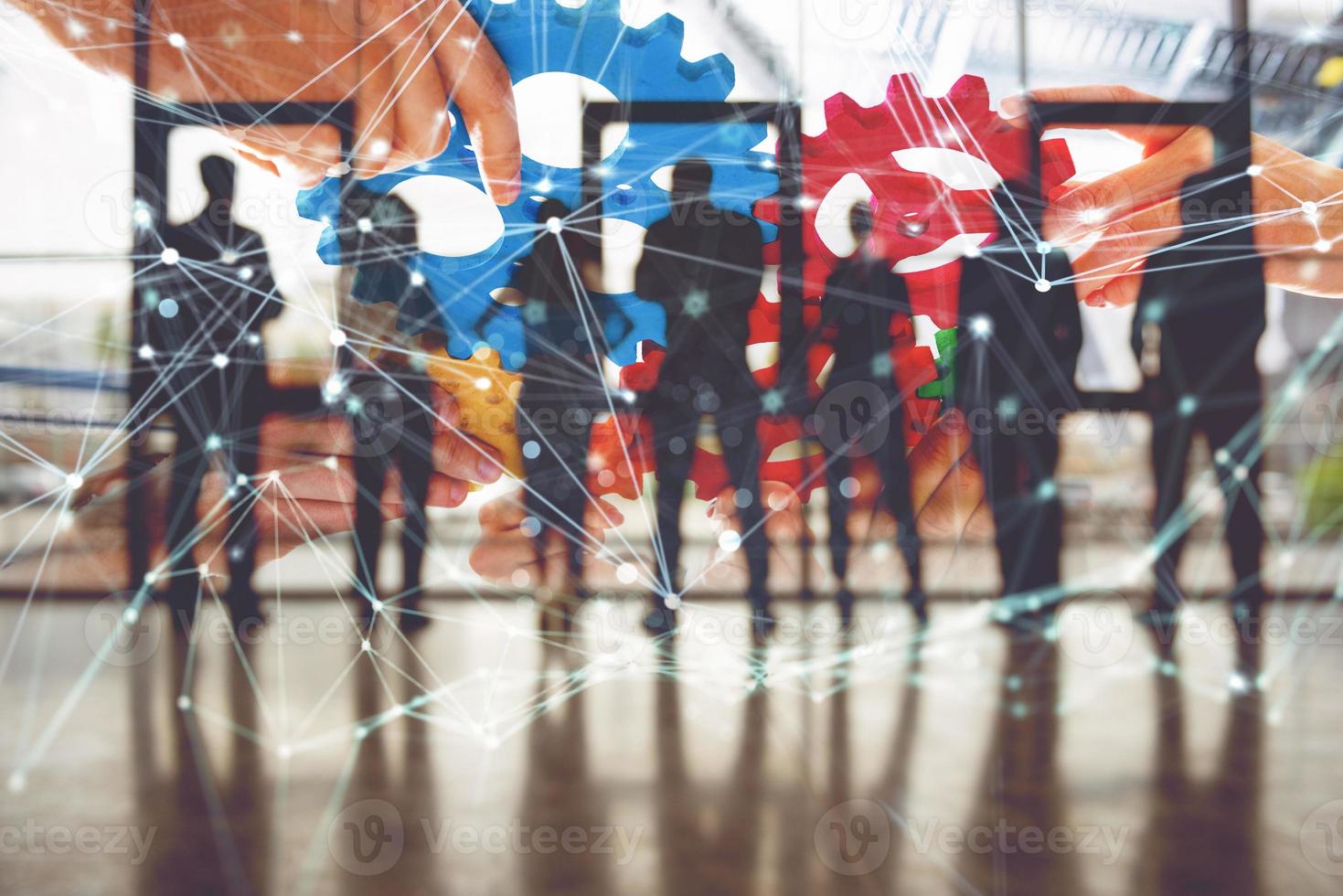 Business team connect pieces of gears. Teamwork, partnership and integration concept. double exposure with light effects photo