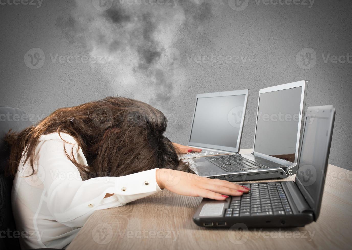 Stressed businesswoman due to overwork photo
