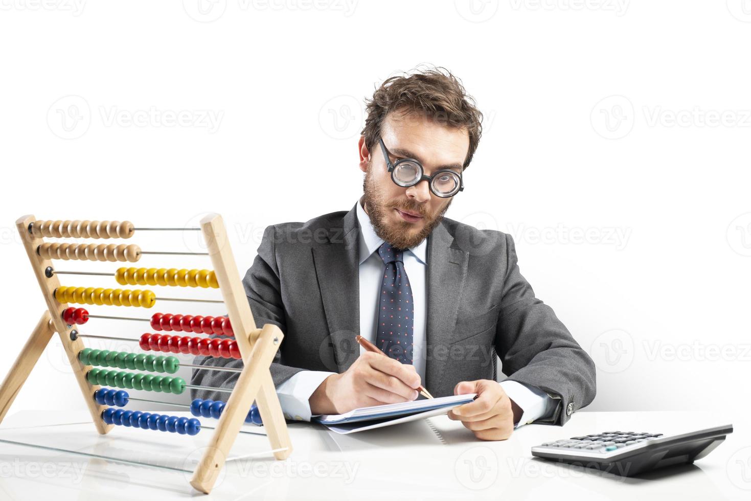 Nerd accountant does calculation of company revenue photo