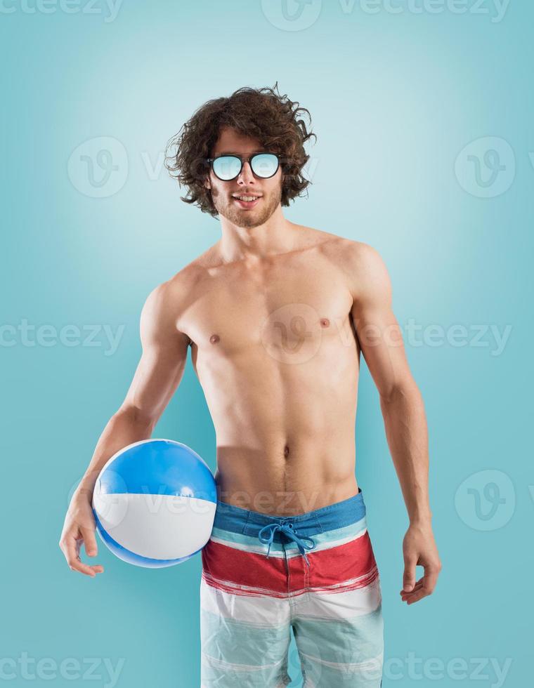 Boy with swimsuit on light blue background photo