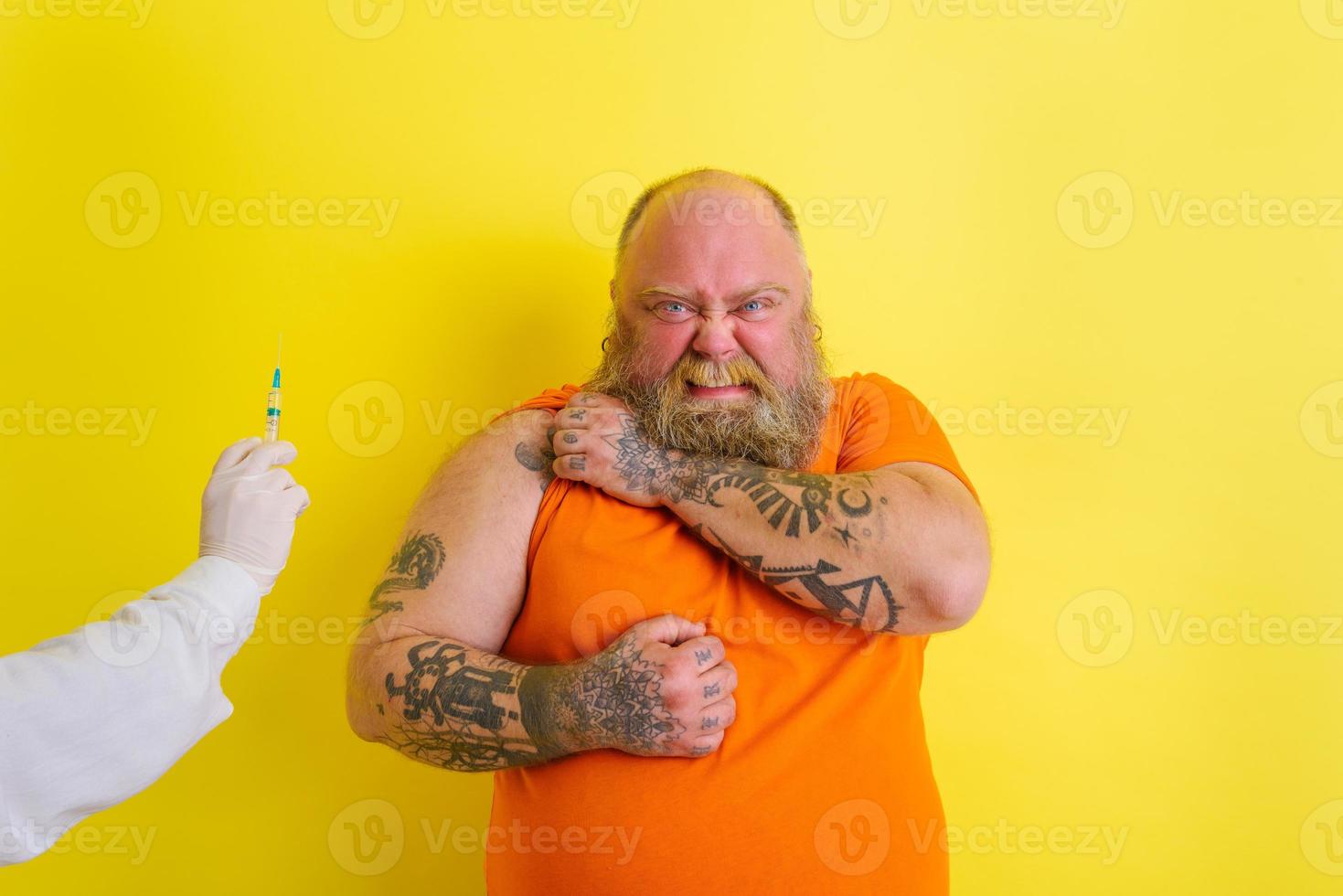 Thoughtful man is afraid of getting the covid-19 vaccine photo